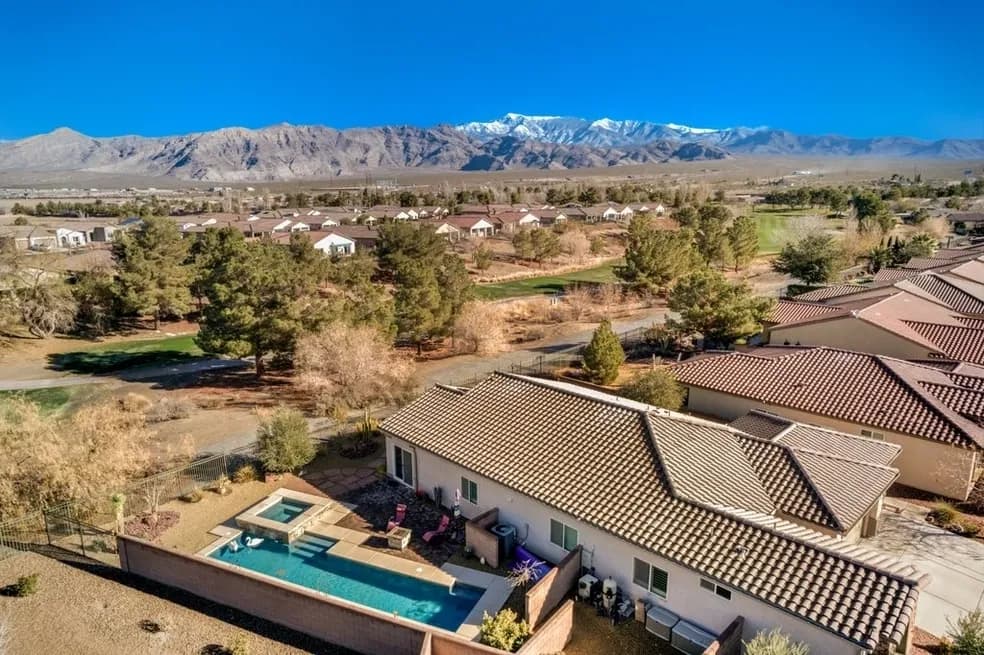 Aerial view of a private home with pool near the golf course